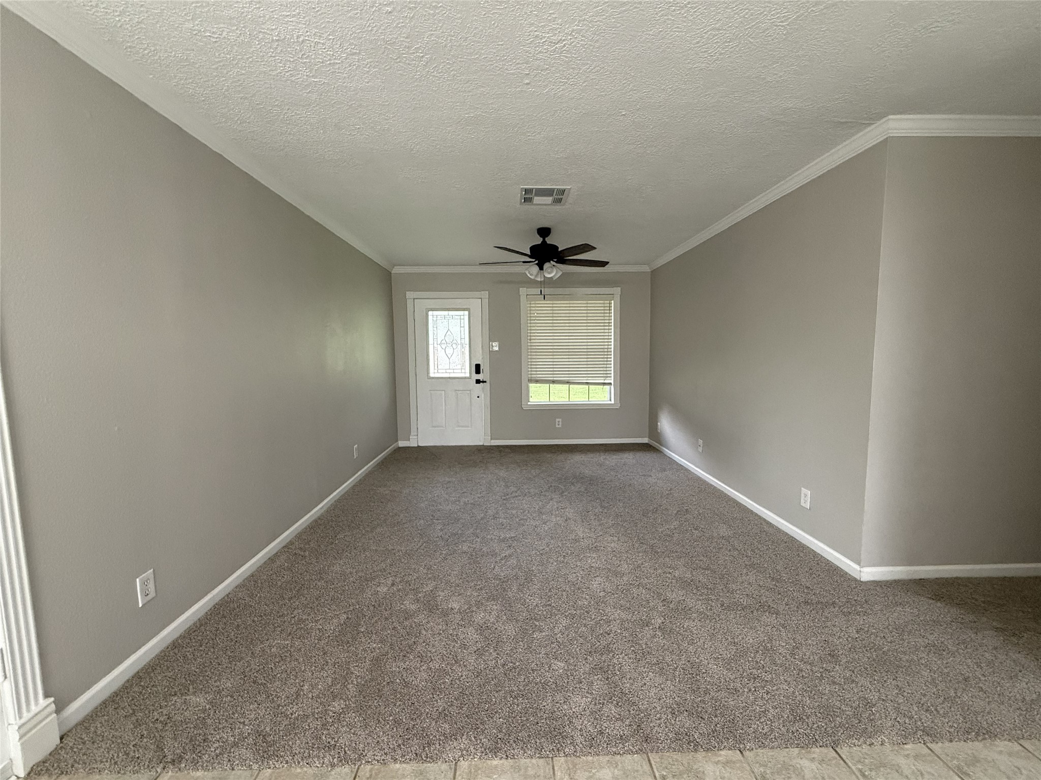 1902 Trinity League City, TX 77573 - Photo 3 of 11 an empty room with windows and chandelier fan