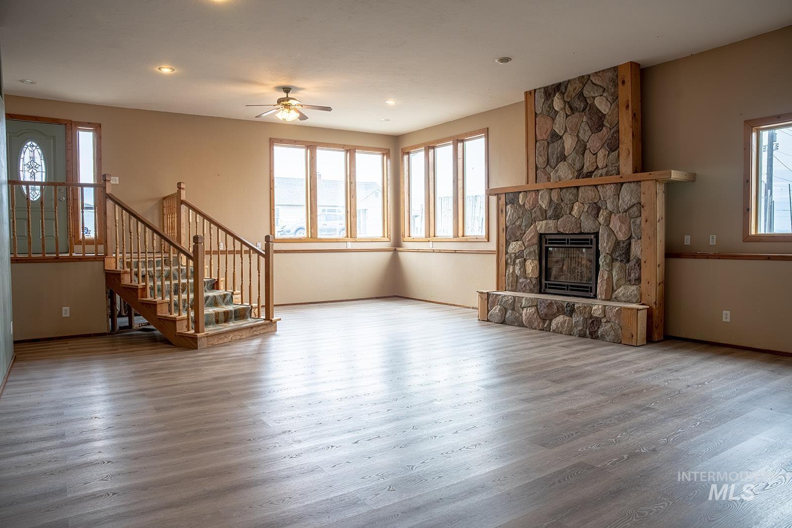 1357 Pound Lane Clarkston, WA 99403 - Photo 13 of 38 Unfurnished living room featuring ceiling fan, wood finished floors, a fireplace, and recessed lighting