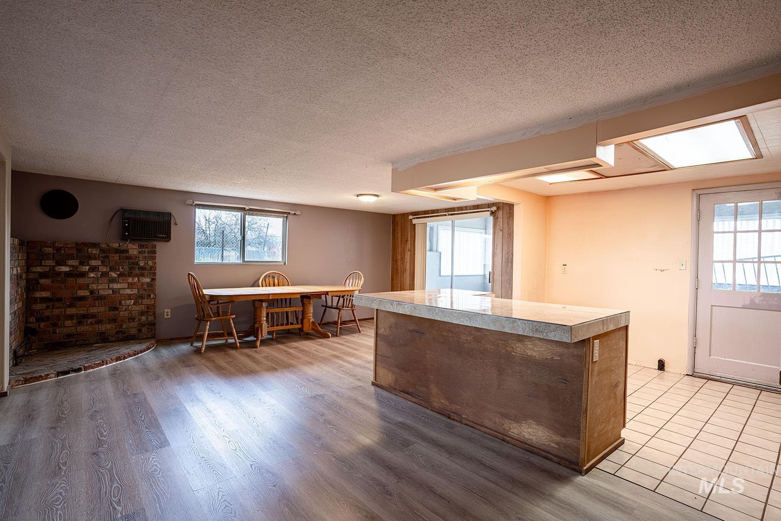 1357 Pound Lane Clarkston, WA 99403 - Photo 17 of 38 Kitchen featuring dark wood finished floors, a center island, light countertops, and a textured ceiling