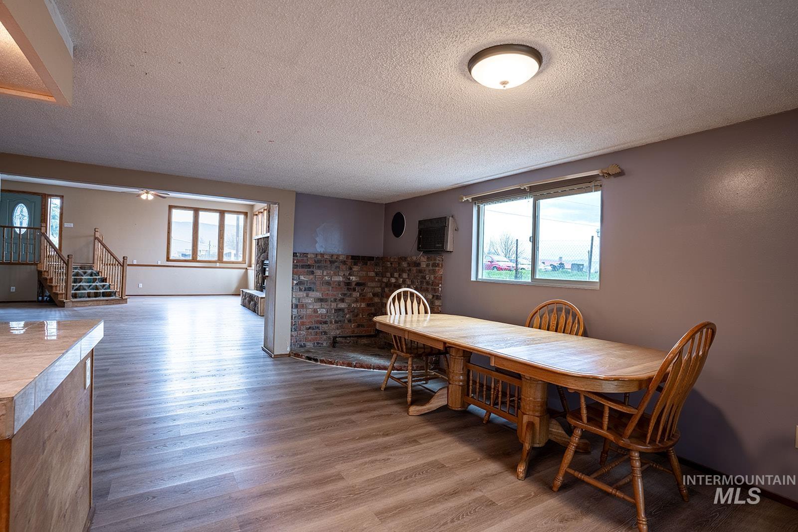 1357 Pound Lane Clarkston, WA 99403 - Photo 19 of 38 Dining room featuring light wood-style flooring and a textured ceiling