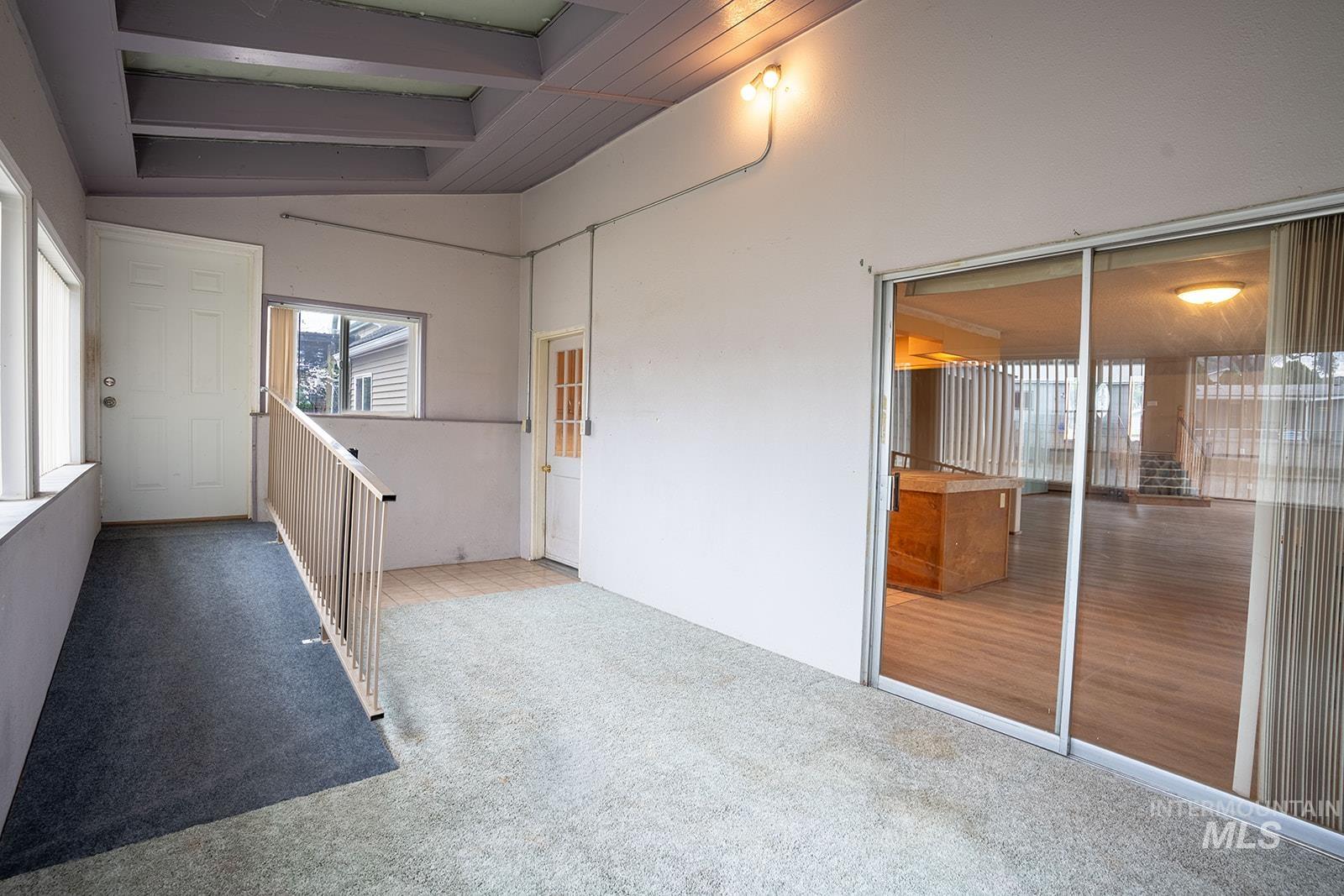 1357 Pound Lane Clarkston, WA 99403 - Photo 20 of 38 Carpeted spare room featuring vaulted ceiling with beams