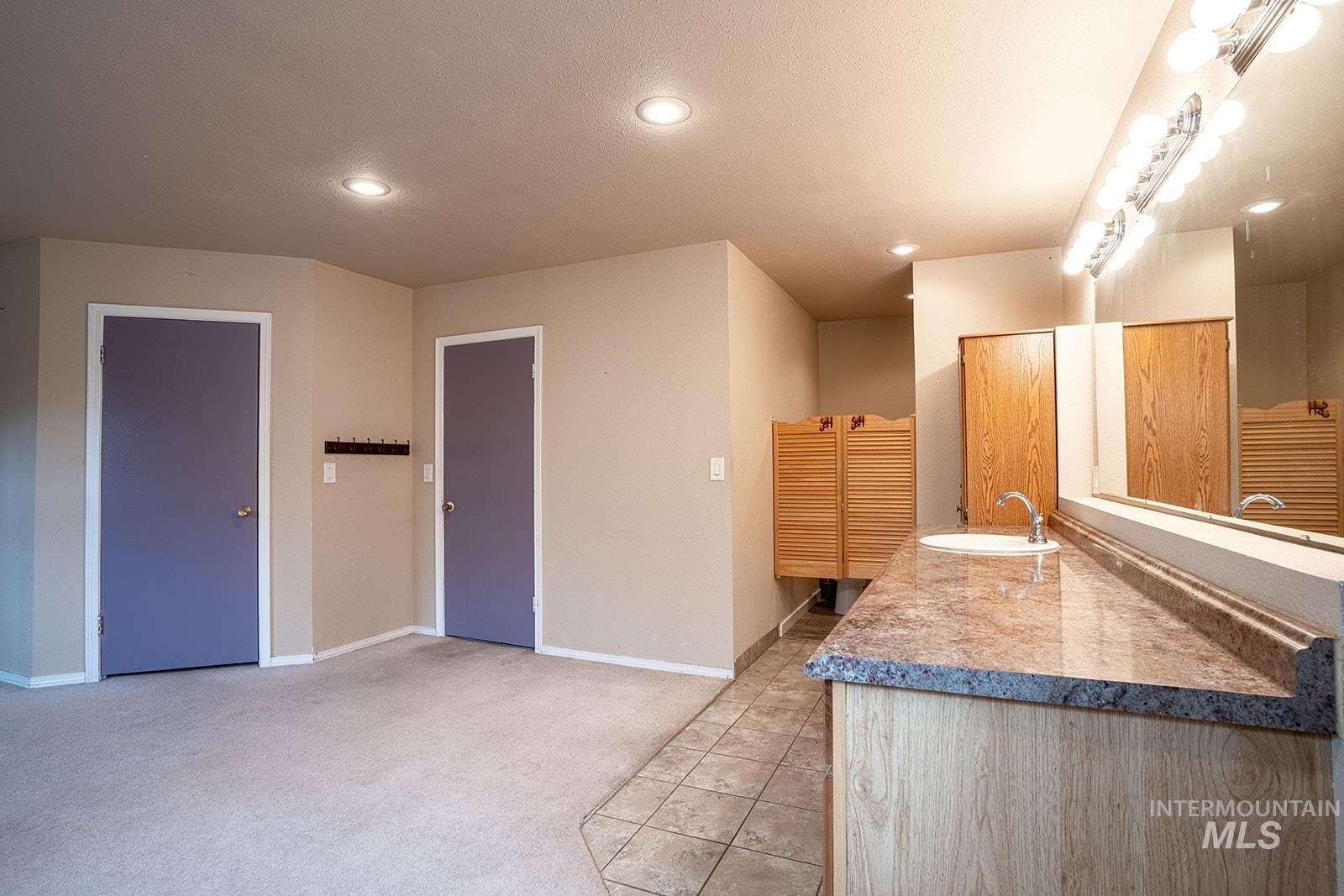 1357 Pound Lane Clarkston, WA 99403 - Photo 22 of 38 Kitchen with light tile patterned floors, light colored carpet, recessed lighting, and light countertops