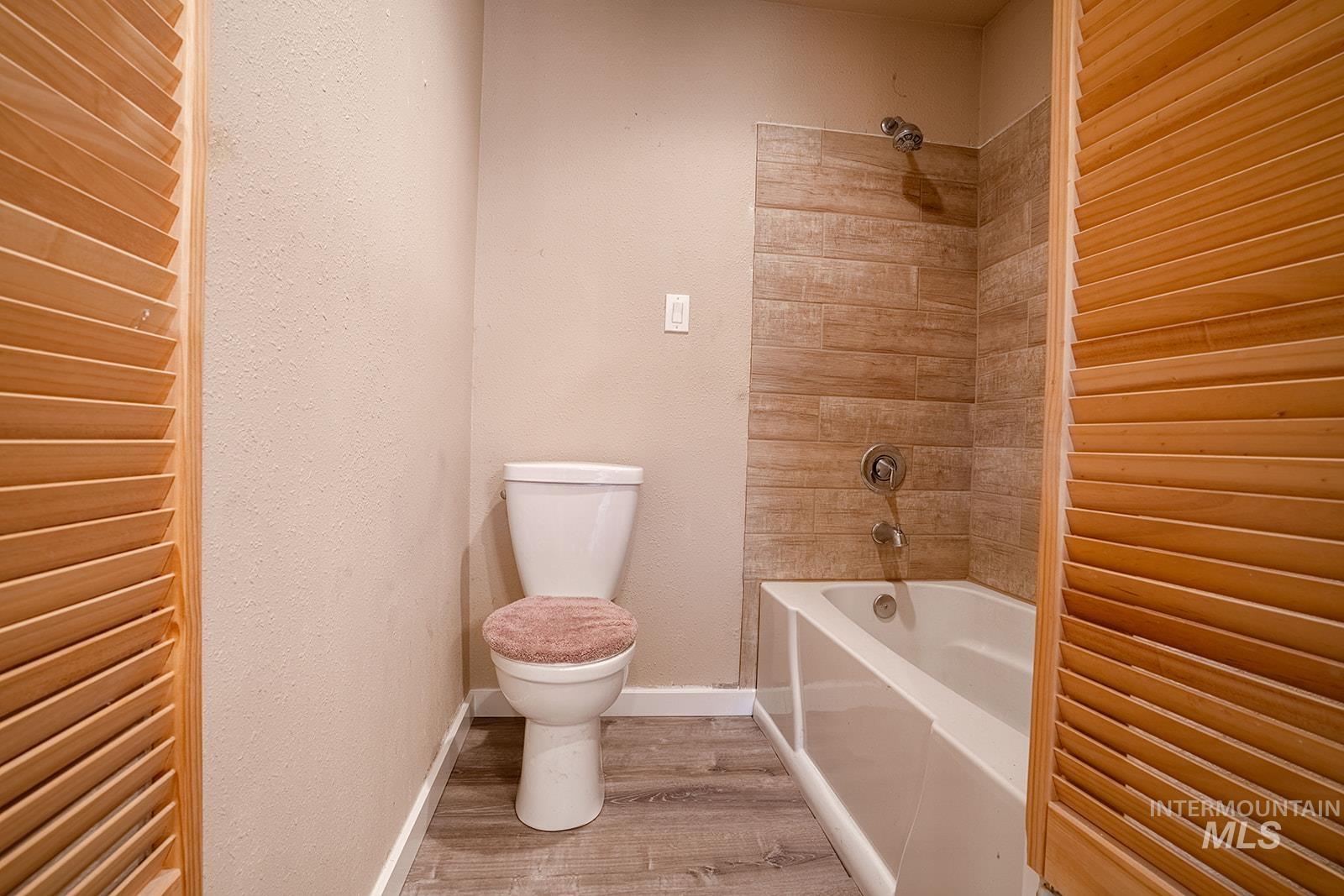 1357 Pound Lane Clarkston, WA 99403 - Photo 23 of 38 Bathroom featuring a textured wall, shower / washtub combination, and light wood finished floors