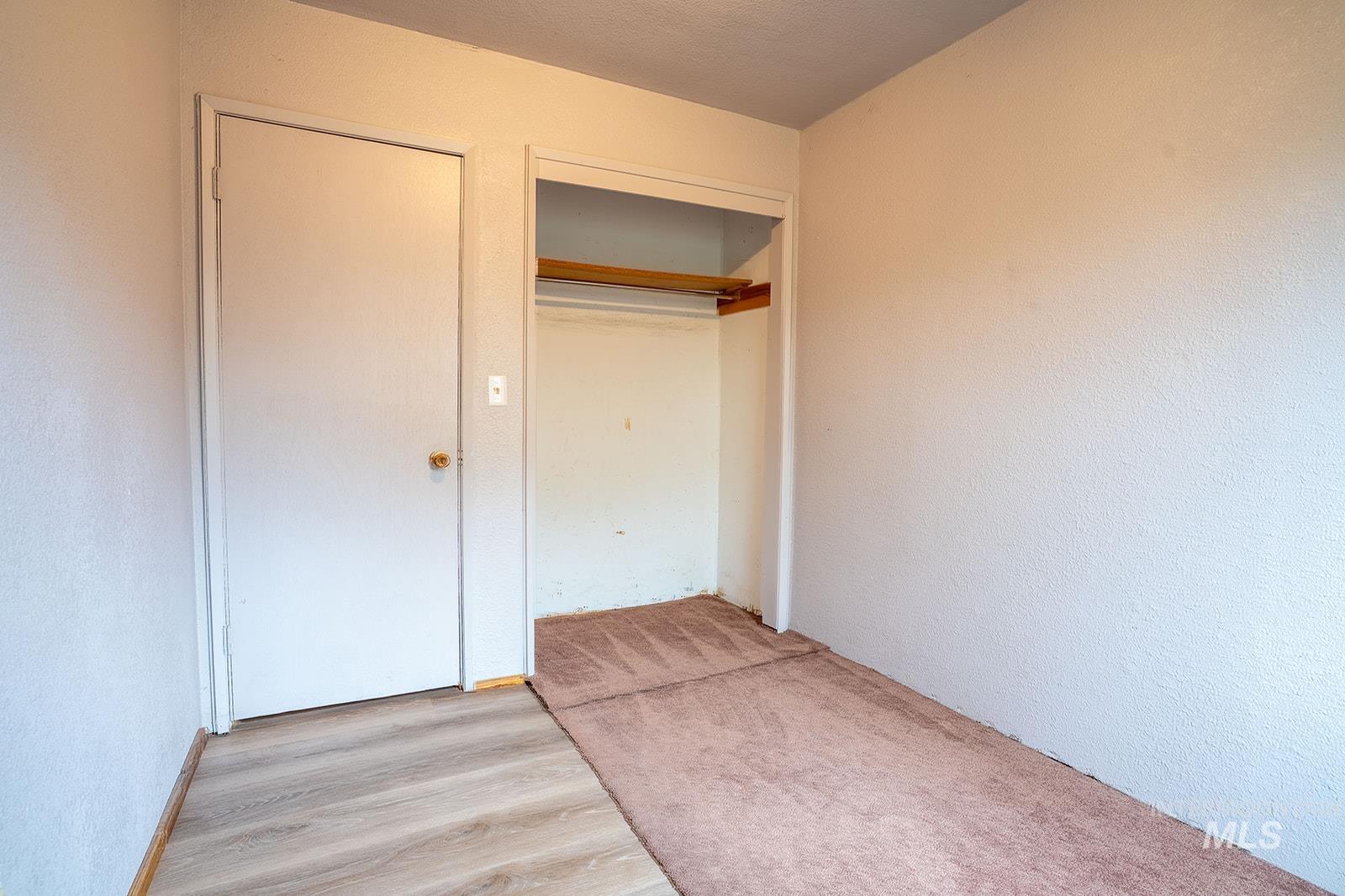 1357 Pound Lane Clarkston, WA 99403 - Photo 26 of 38 Unfurnished bedroom with light wood finished floors, a textured wall, and a closet