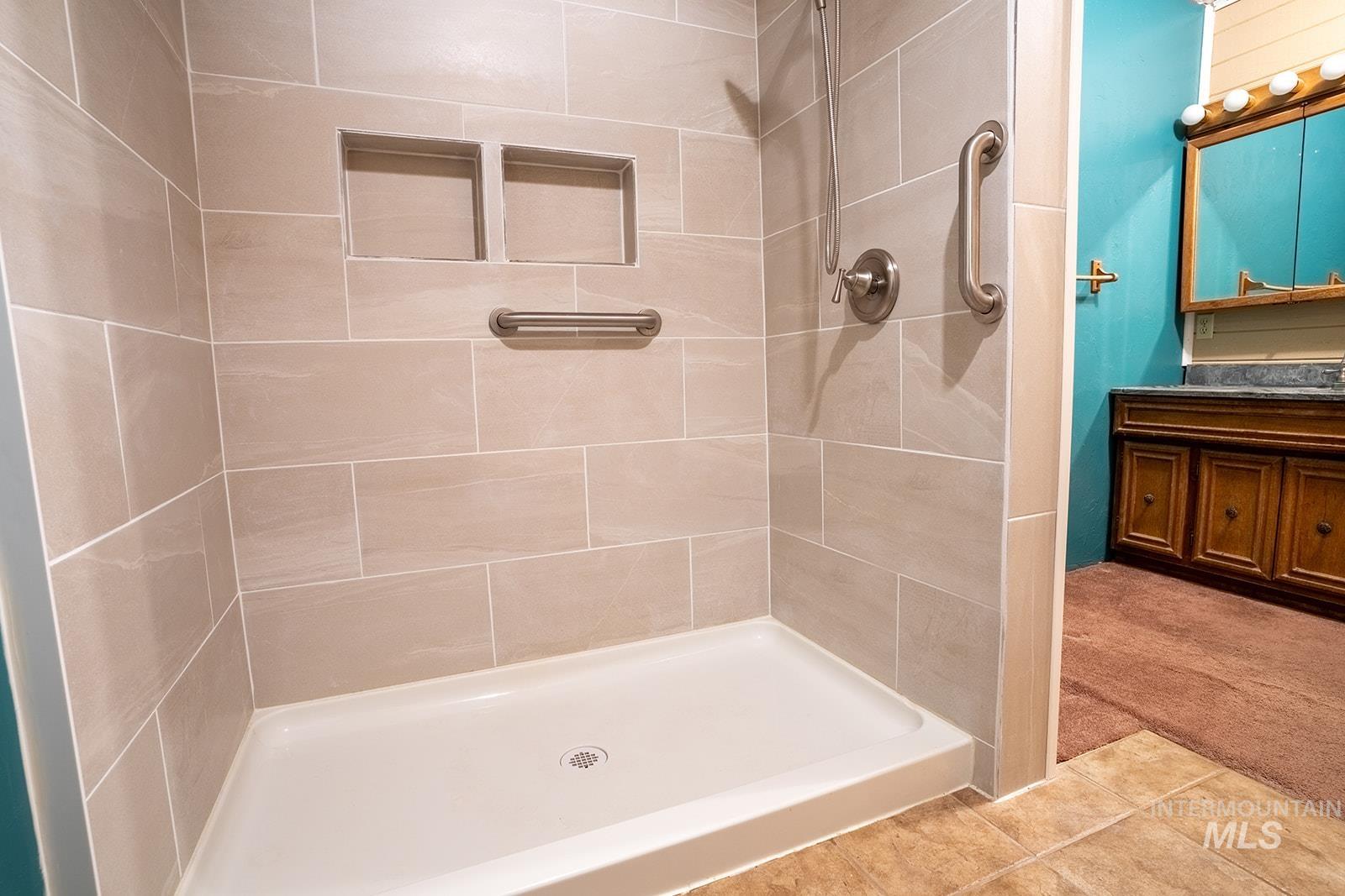 1357 Pound Lane Clarkston, WA 99403 - Photo 28 of 38 Bathroom featuring a shower stall, light colored carpet, and light tile patterned floors