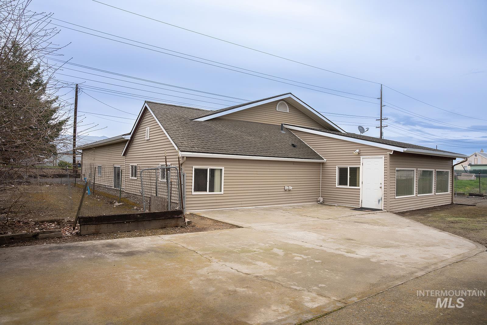 1357 Pound Lane Clarkston, WA 99403 - Photo 4 of 38 Rear view of house with a shingled roof and driveway