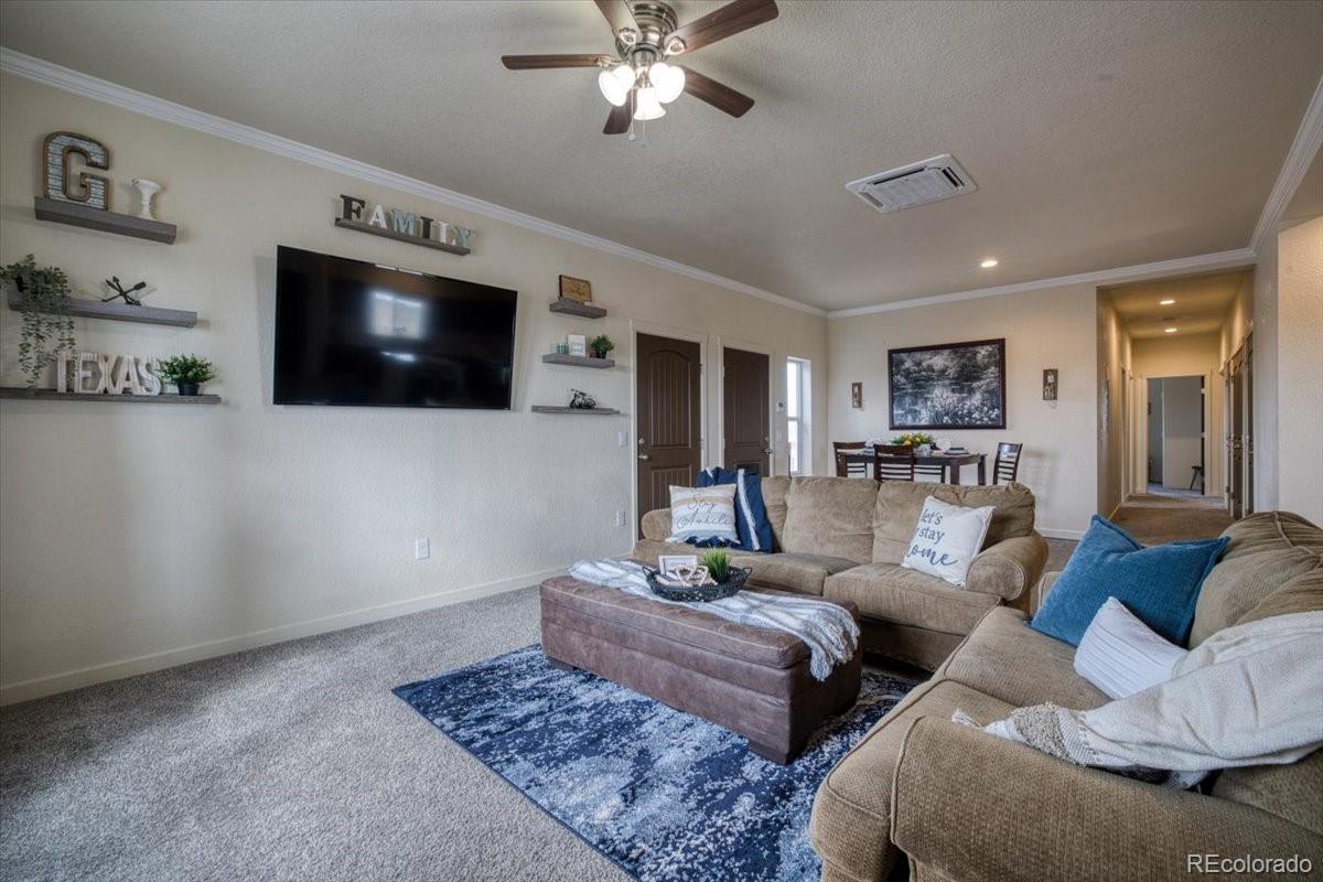1215 North Yoder Road Yoder, CO 80864 - Photo 12 of 37 a living room with furniture and a flat screen tv