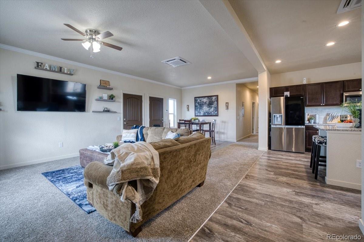 1215 North Yoder Road Yoder, CO 80864 - Photo 14 of 37 a living room with furniture and a flat screen tv