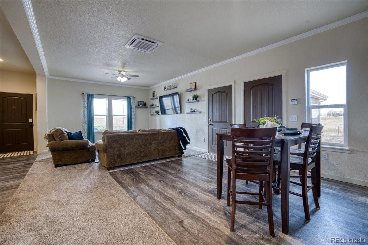 1215 North Yoder Road Yoder, CO 80864 - Photo 17 of 37 a living room with furniture and wooden floor