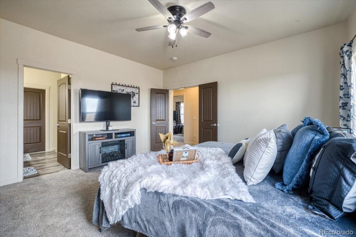 1215 North Yoder Road Yoder, CO 80864 - Photo 20 of 37 a bedroom with a bed and a flat screen tv