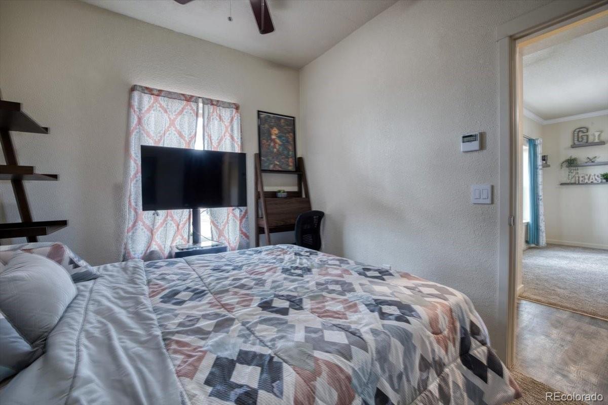 1215 North Yoder Road Yoder, CO 80864 - Photo 24 of 37 a bedroom with a bed and a flat screen tv