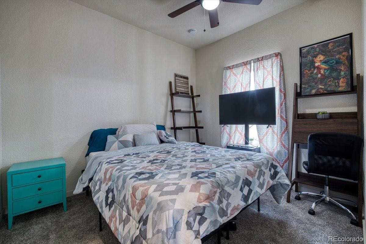 1215 North Yoder Road Yoder, CO 80864 - Photo 25 of 37 a bedroom with a bed and a flat screen tv