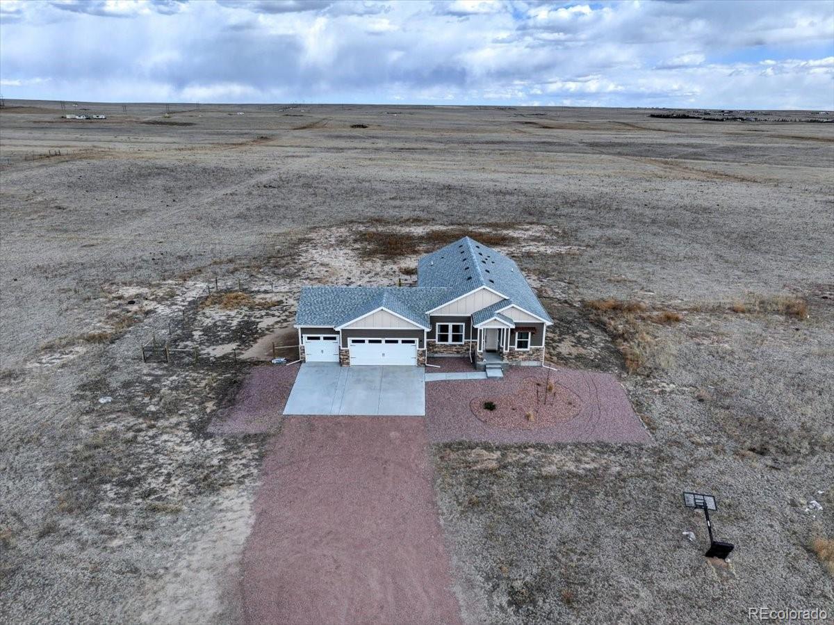 1215 North Yoder Road Yoder, CO 80864 - Photo 4 of 37 a view of a house with a yard