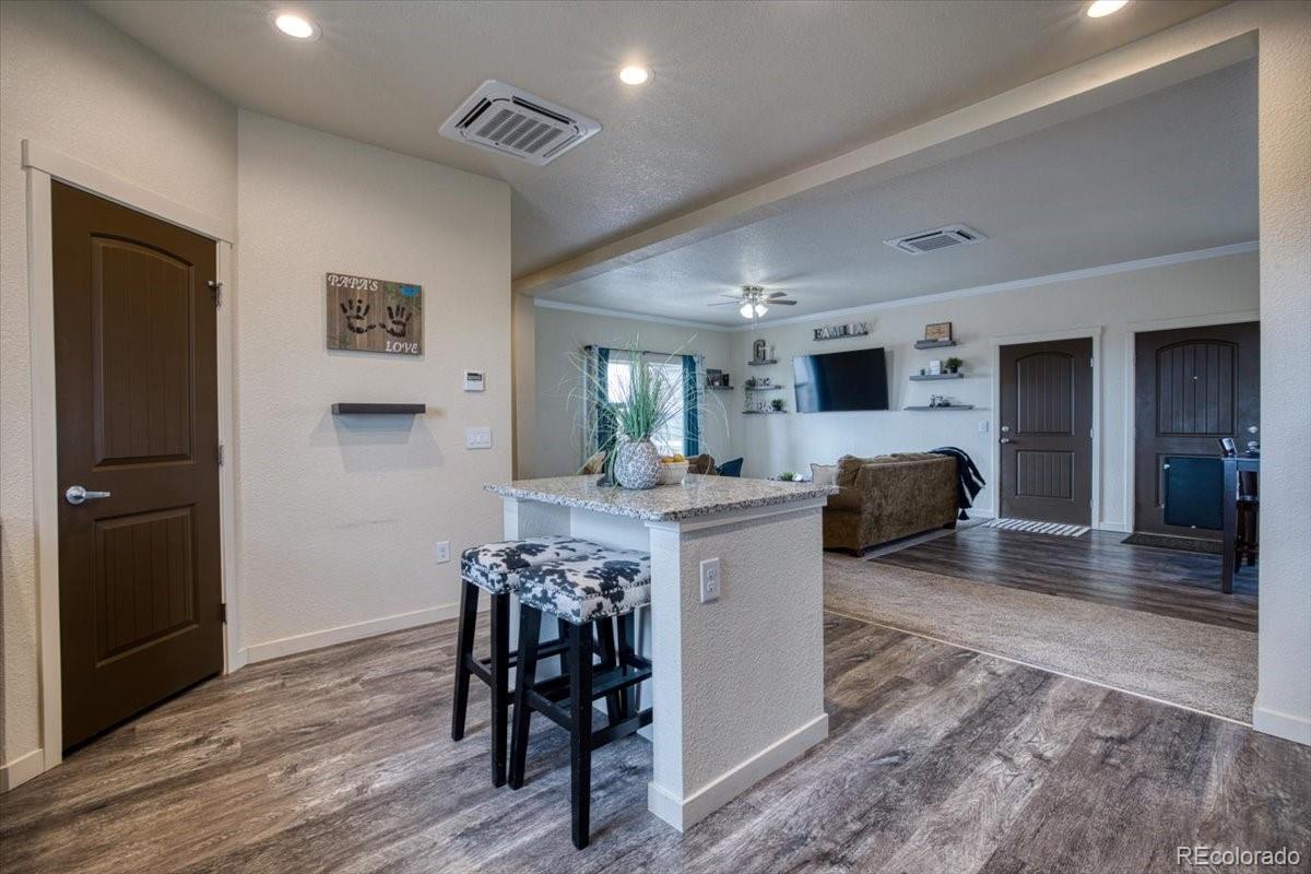 1215 North Yoder Road Yoder, CO 80864 - Photo 10 of 37 a living room with furniture and a wooden floor
