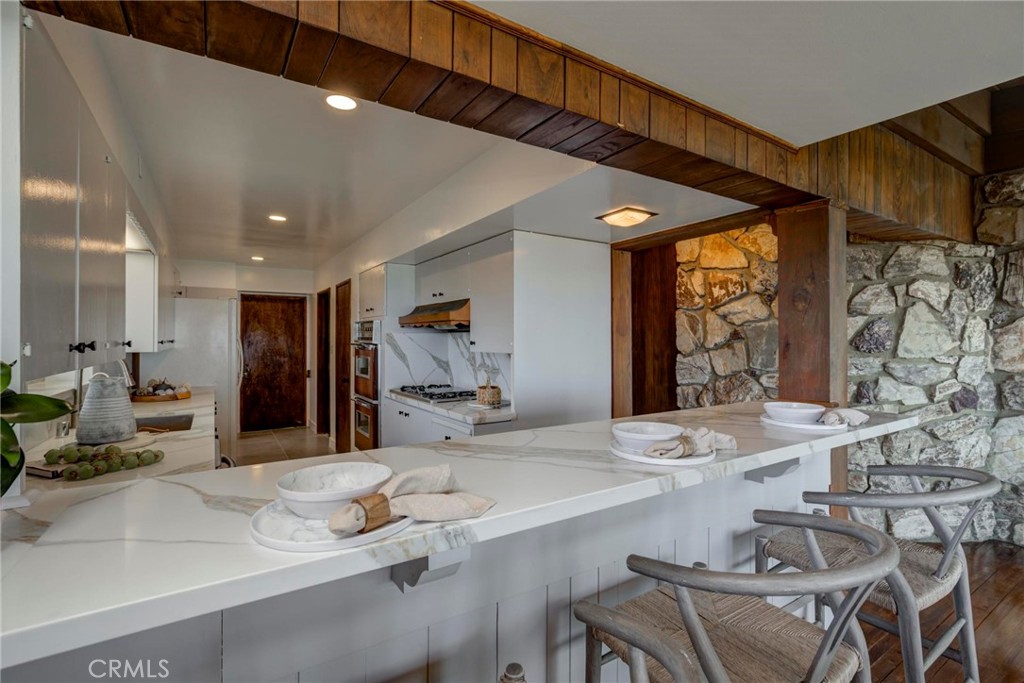 4612 Beauvais Road Rancho Palos Verdes, CA 90275 - Photo 18 of 40 a room with stainless steel appliances kitchen island granite countertop a sink and a refrigerator