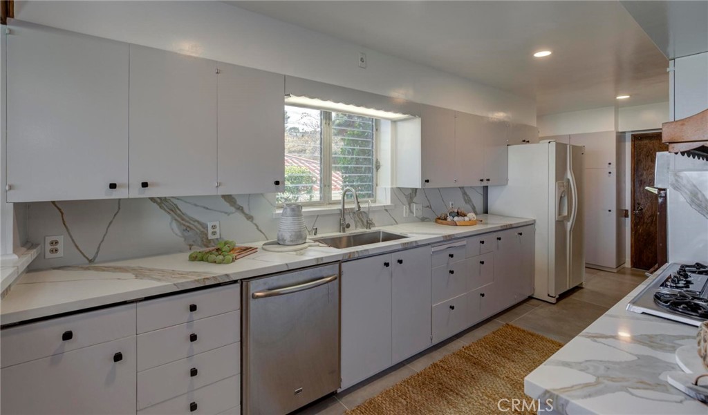 4612 Beauvais Road Rancho Palos Verdes, CA 90275 - Photo 19 of 40 a kitchen with granite countertop a sink stainless steel appliances and cabinets