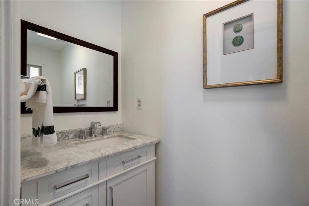 4612 Beauvais Road Rancho Palos Verdes, CA 90275 - Photo 24 of 40 a bathroom with a granite countertop sink and a mirror