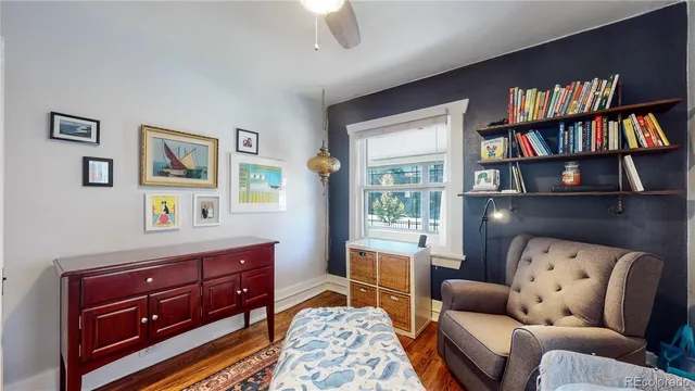 a living room with furniture and a book shelf