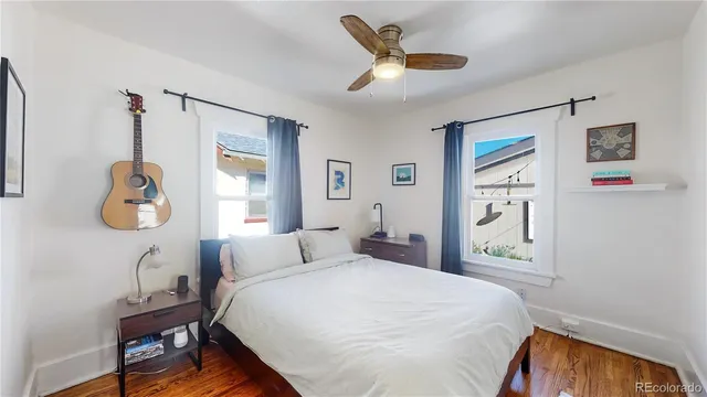 a bedroom with a bed a window and a chandelier