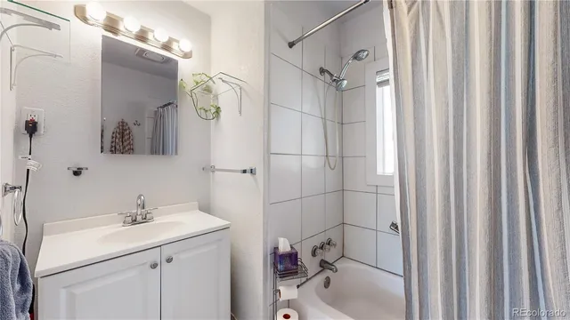 a bathroom with a sink a toilet a mirror and shower