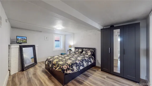 a bed sitting in a bedroom next to a window with closet