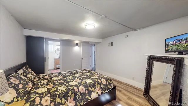 a bedroom with a bed and a mirror