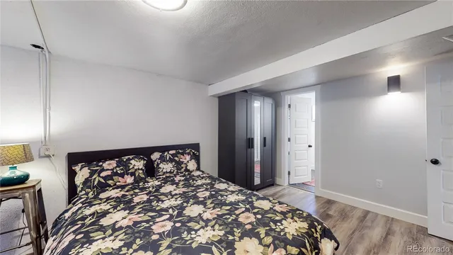 a large bed in a bedroom next to a window and a chandelier