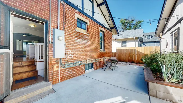 a backyard of a house with outdoor seating