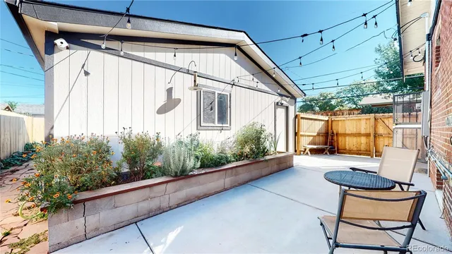 a backyard of a house with chairs