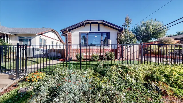 a view of a house with a small yard and plants