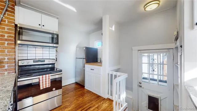 a kitchen with stainless steel appliances a stove microwave and a refrigerator