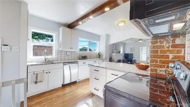 a kitchen with stainless steel appliances a stove a sink and a refrigerator