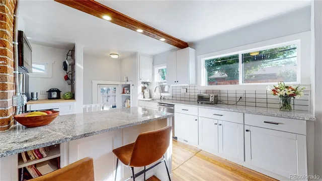 a kitchen with stainless steel appliances granite countertop a sink and cabinets