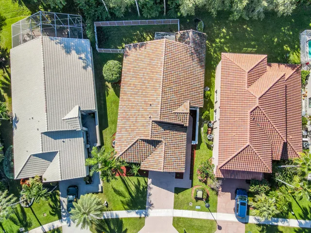 an aerial view of a house with a yard and potted plants