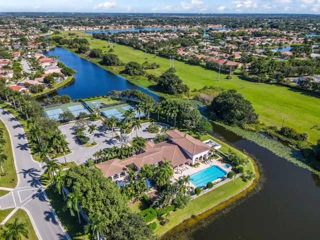 an aerial view of a residential houses with outdoor space and river view