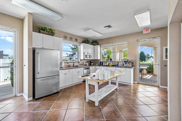 a kitchen with stainless steel appliances a refrigerator sink and cabinets
