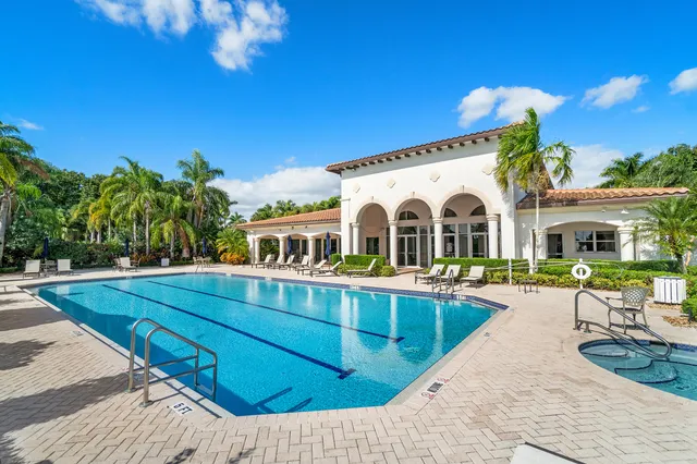 a view of a house with swimming pool and sitting area