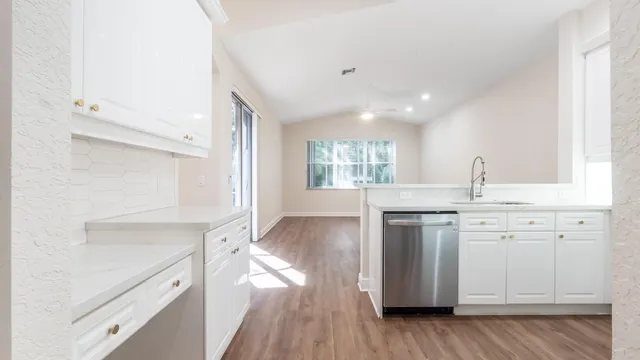 a kitchen with a sink stove and cabinets