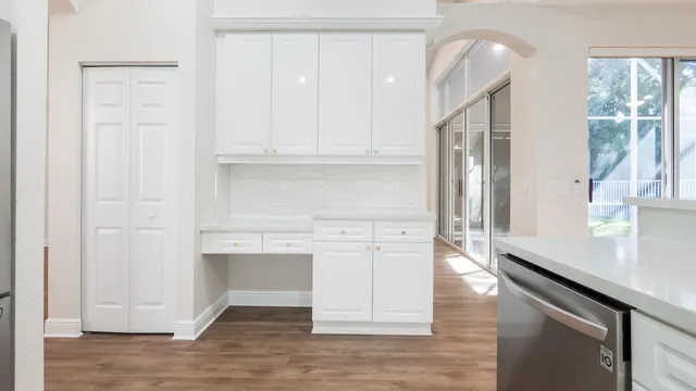 a view of cabinets with wooden floor and window