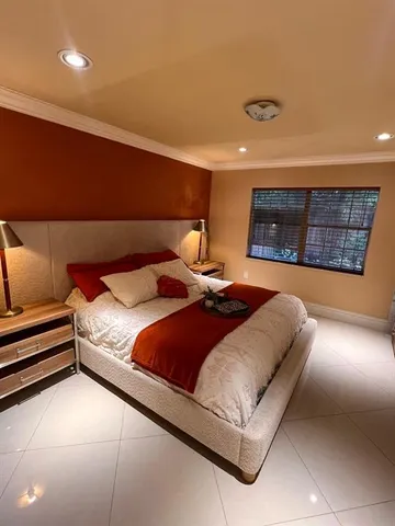 a bathroom with a granite countertop toilet sink and mirror