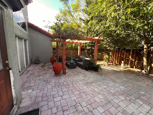 a swimming pool with outdoor seating and yard