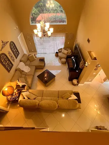 a living room with furniture chandelier and a chandelier