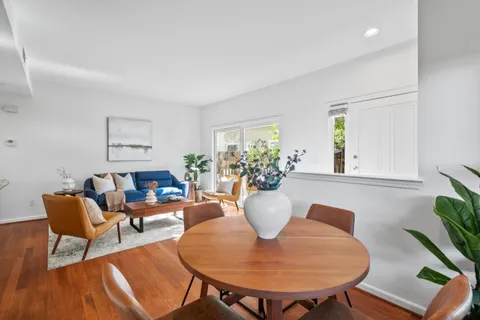 a living room with furniture a window and a dining table