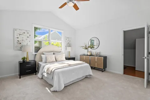 a bedroom with a bed a couch and a window