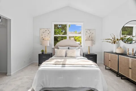 a bedroom with a bed and a view of kitchen