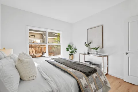 a bedroom with a bed and a night stand