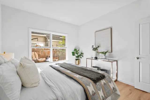 a bedroom with a bed and a night stand