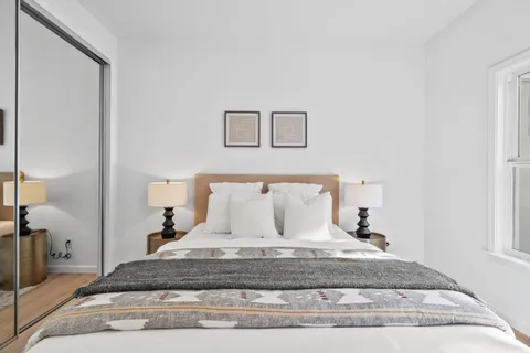 a bedroom with a bed and a table