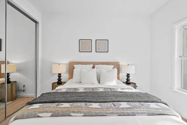 a bedroom with a bed and a table