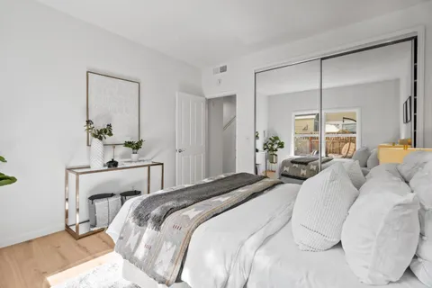 a bathroom with a toilet a sink a mirror a vanity and shower